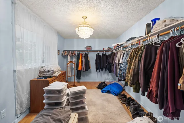 a view of walk in closet with clothes and shoes