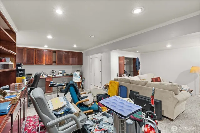 a living room with lots of furniture and a view of kitchen