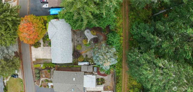 an aerial view of a residential houses with yard