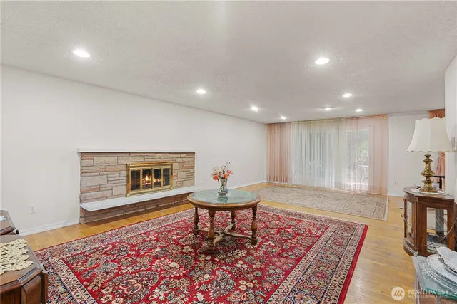 a living room with a rug and a wooden floor