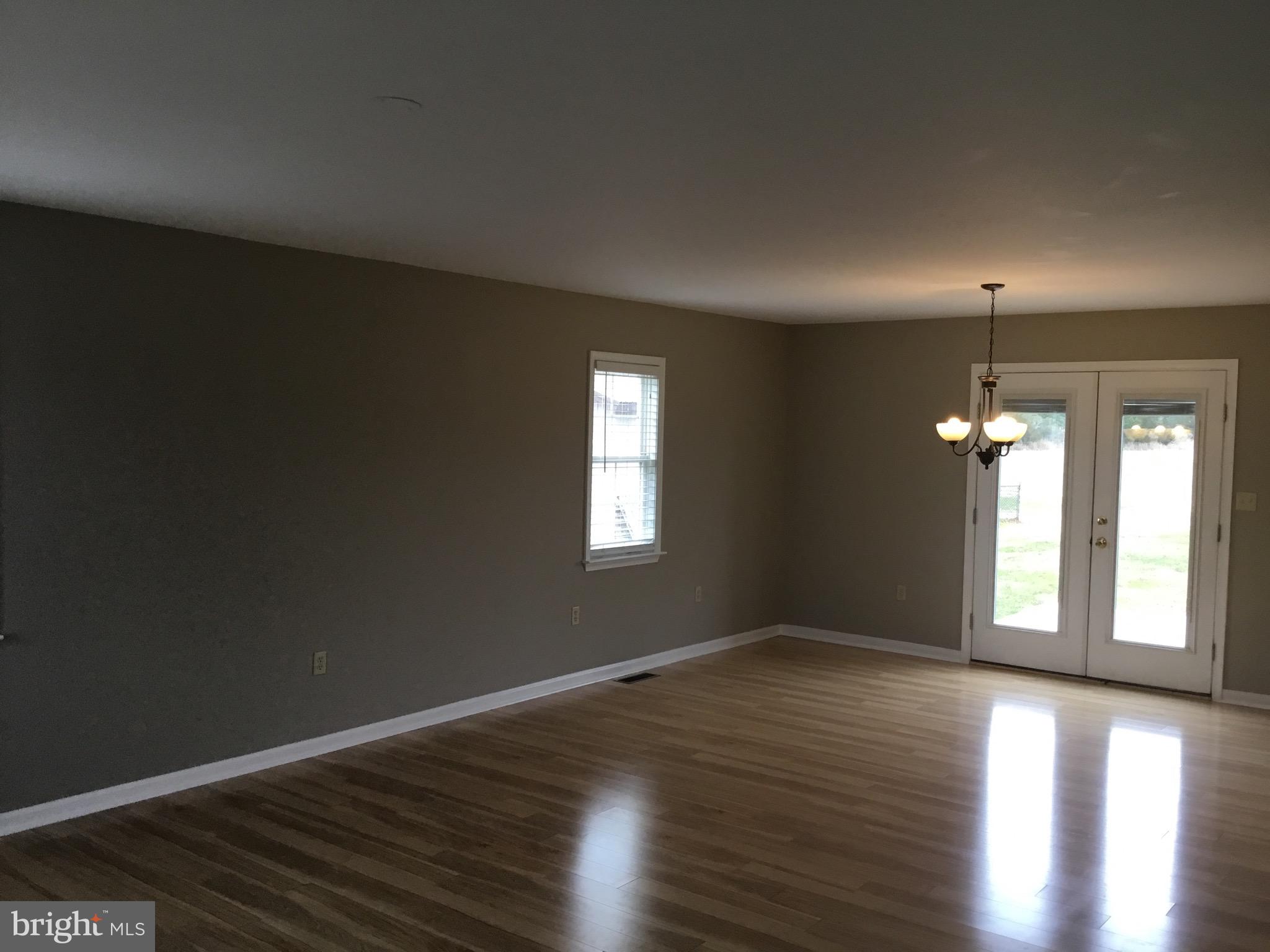 4810 Jacksonville Road Crisfield, MD 21817 - Photo 21 of 38 an empty room with wooden floor and windows