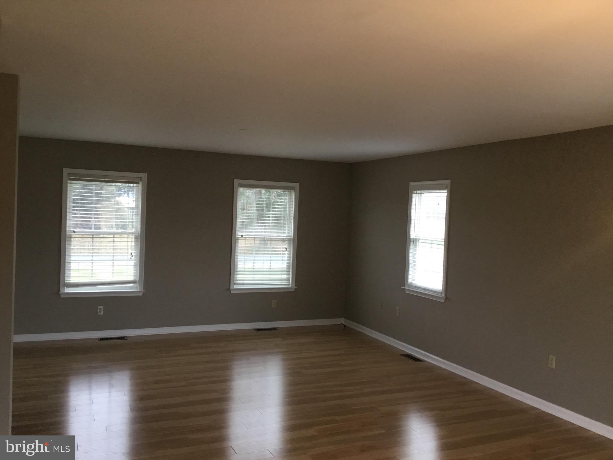 4810 Jacksonville Road Crisfield, MD 21817 - Photo 22 of 38 a view of an empty room with wooden floor and a window