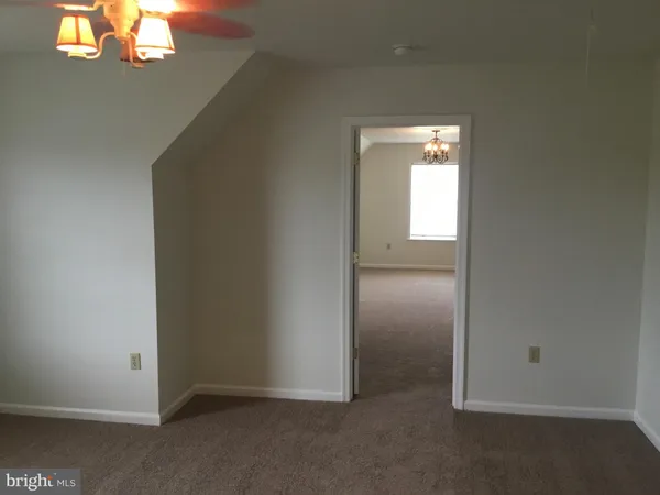 an empty room with closet and windows
