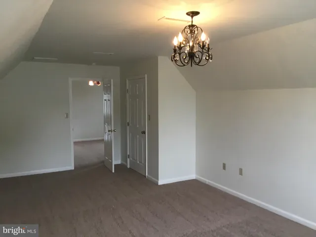 a dining room with chandelier and window