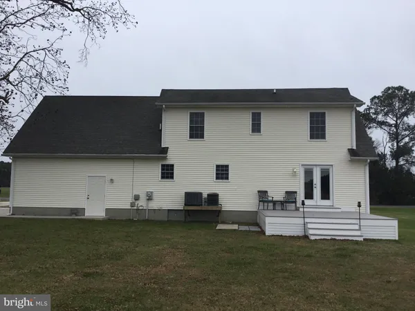 a view of a white house with a yard