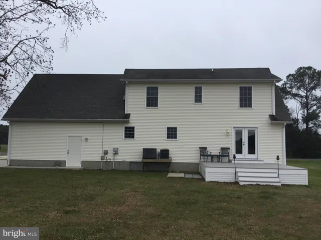 a view of a white house with a yard
