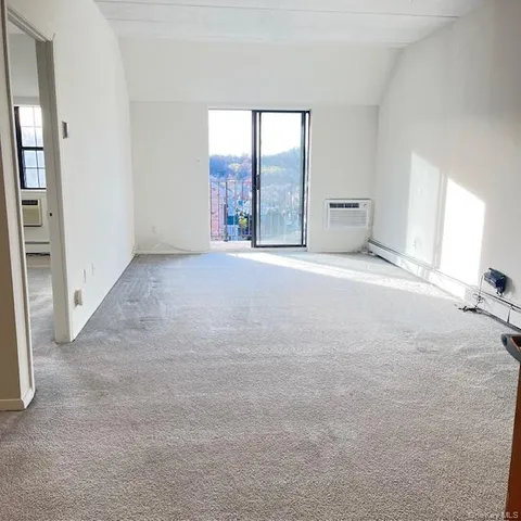 an empty room with windows and entrance