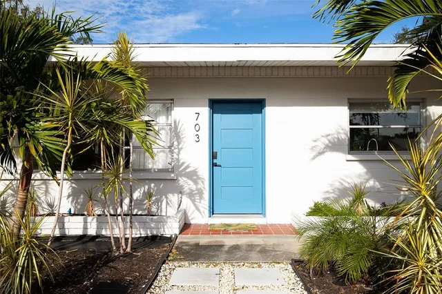 a view of a house with a yard and garage
