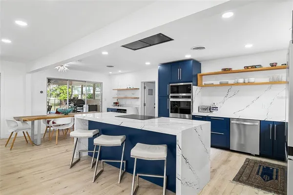 a kitchen with a sink stove and refrigerator