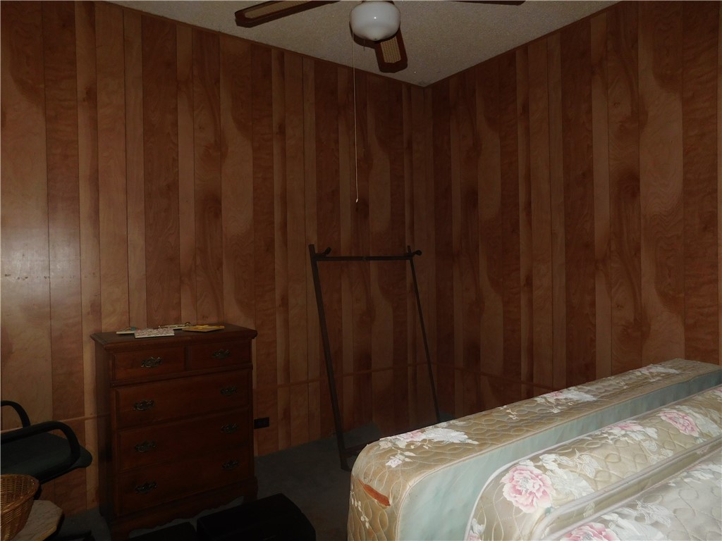 712 East 2nd Street Alice, TX 78332 - Photo 15 of 25 a bedroom with a bed and a curtain