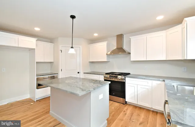 a stove top oven sitting inside of a kitchen