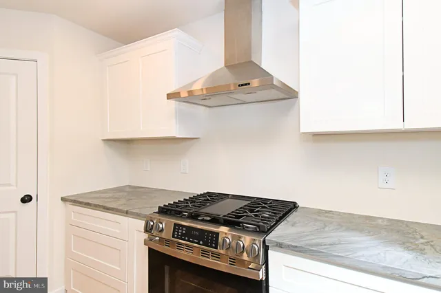 a kitchen with kitchen island granite countertop a stove a sink and a refrigerator