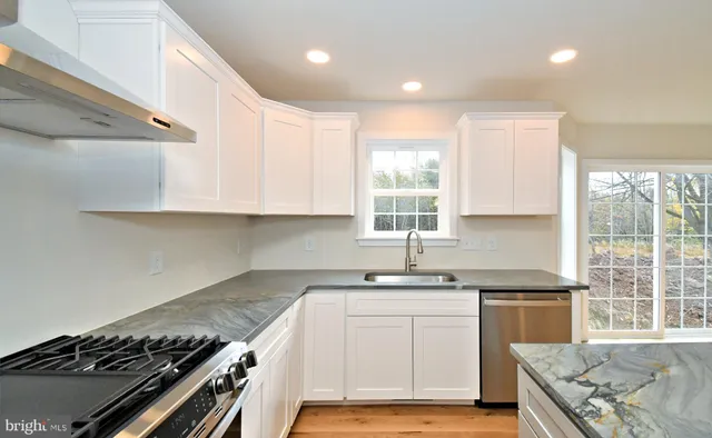 a kitchen with white cabinets and white appliances