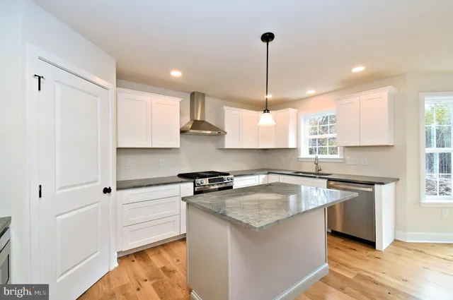 a view of empty room with wooden floor and fireplace