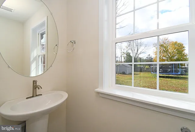 a view of a room with wooden floor staircase and a ceiling fan