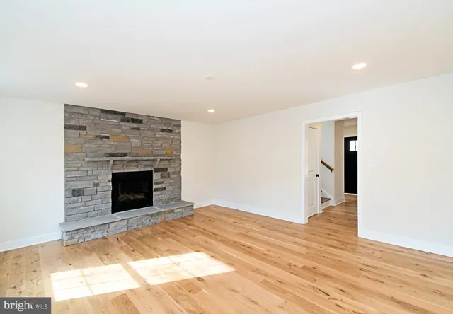 a view of a room with wooden floor and a ceiling fan