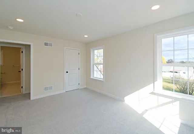 a view of an empty room with wooden roof