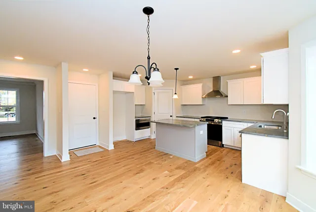 a view of a kitchen with a sink and a chandelier