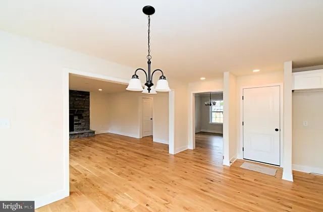 a kitchen with stainless steel appliances granite countertop a stove top oven a sink and a chandelier