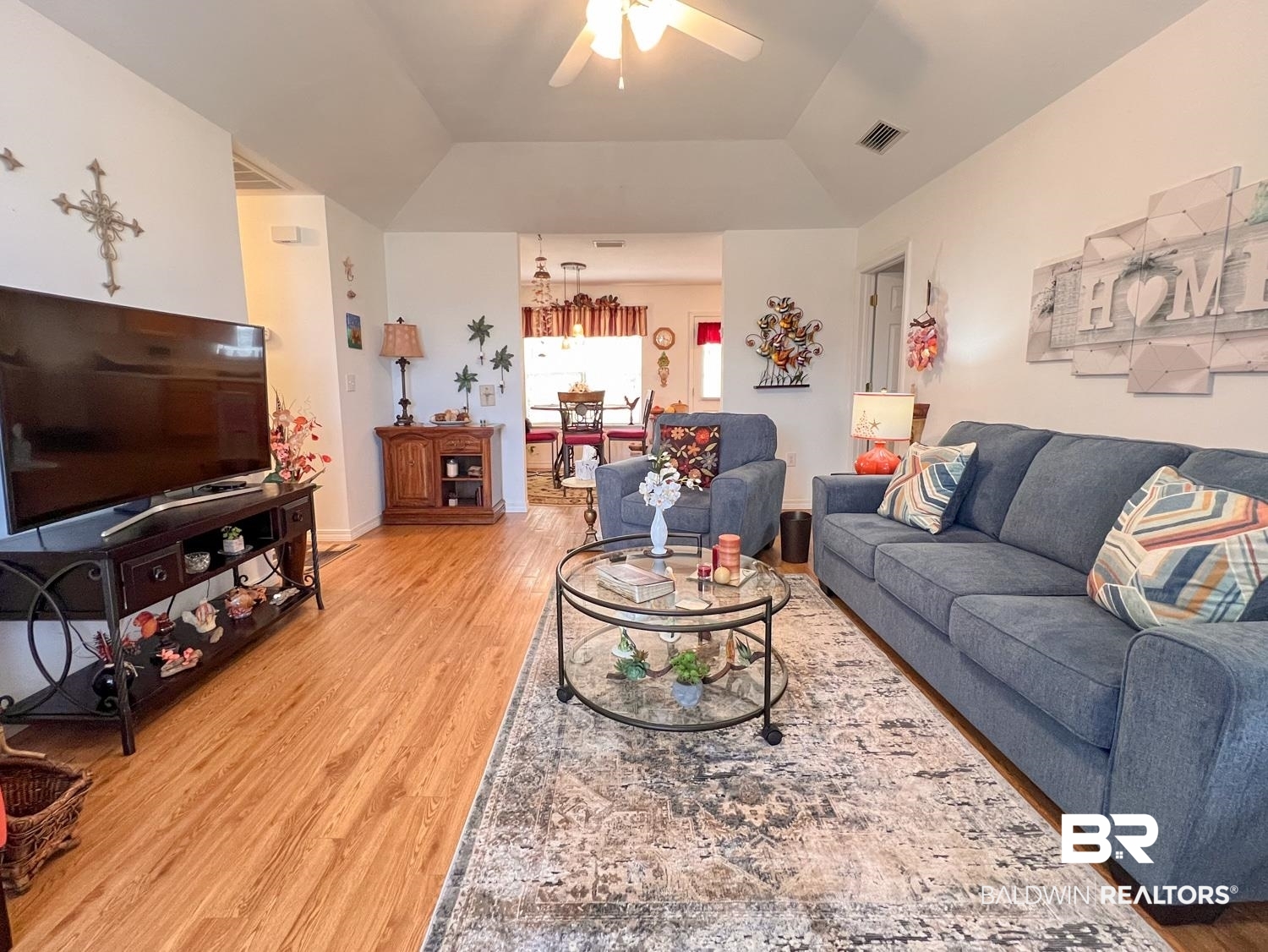 16690 Plum Court Loxley, AL 36551 - Photo 3 of 30 Living room with ceiling fan, vaulted ceiling, and light wood-type flooring