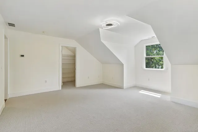 a view of a big room with closet and windows