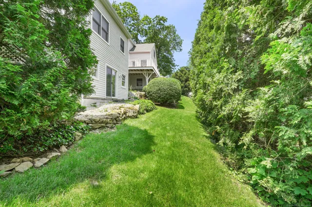 a view of a house with a yard and tree s