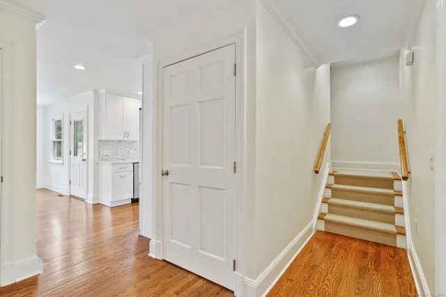a view of an entryway with wooden floor and staircase