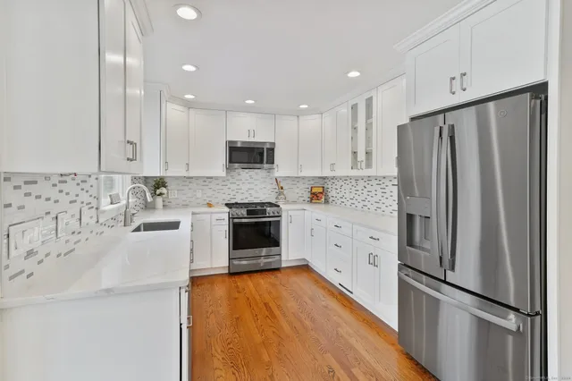 a kitchen with stainless steel appliances a refrigerator sink and microwave