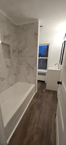 a bathroom with a bathtub and a shower