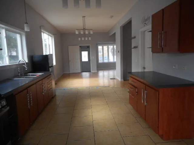 a kitchen with a refrigerator and a sink
