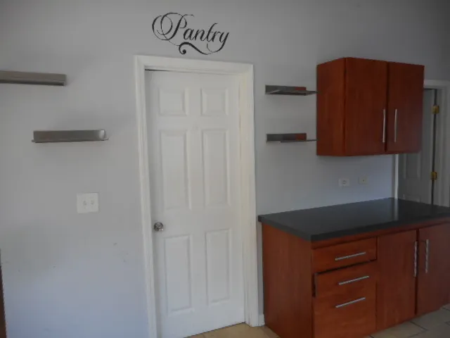 a kitchen with a refrigerator and cabinets