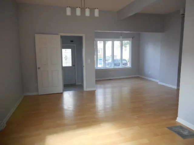 a view of an empty room with glass door