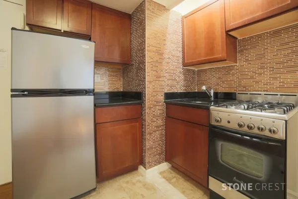 a kitchen with a refrigerator stove and cabinets