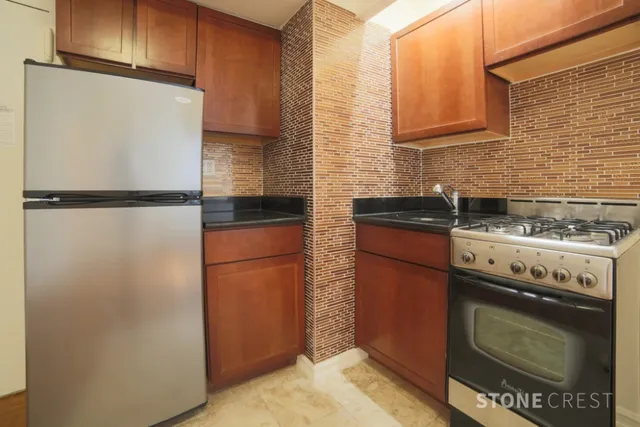 a kitchen with a refrigerator stove and cabinets