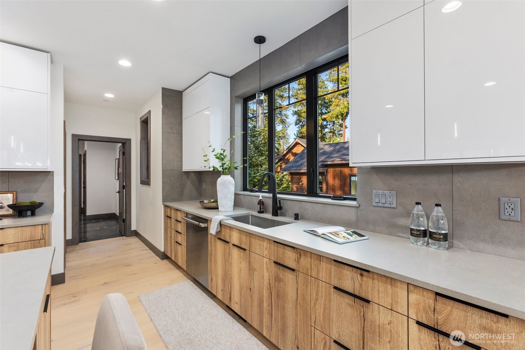 90 Portal Cle Elum, WA 98922 - Photo 9 of 38 a kitchen with a sink a counter top space stainless steel appliances a large window and cabinets