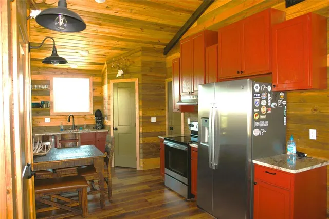 a kitchen with a refrigerator and a table