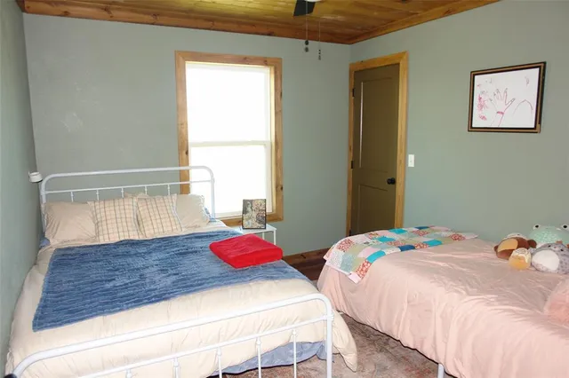 a bedroom with a bed and window