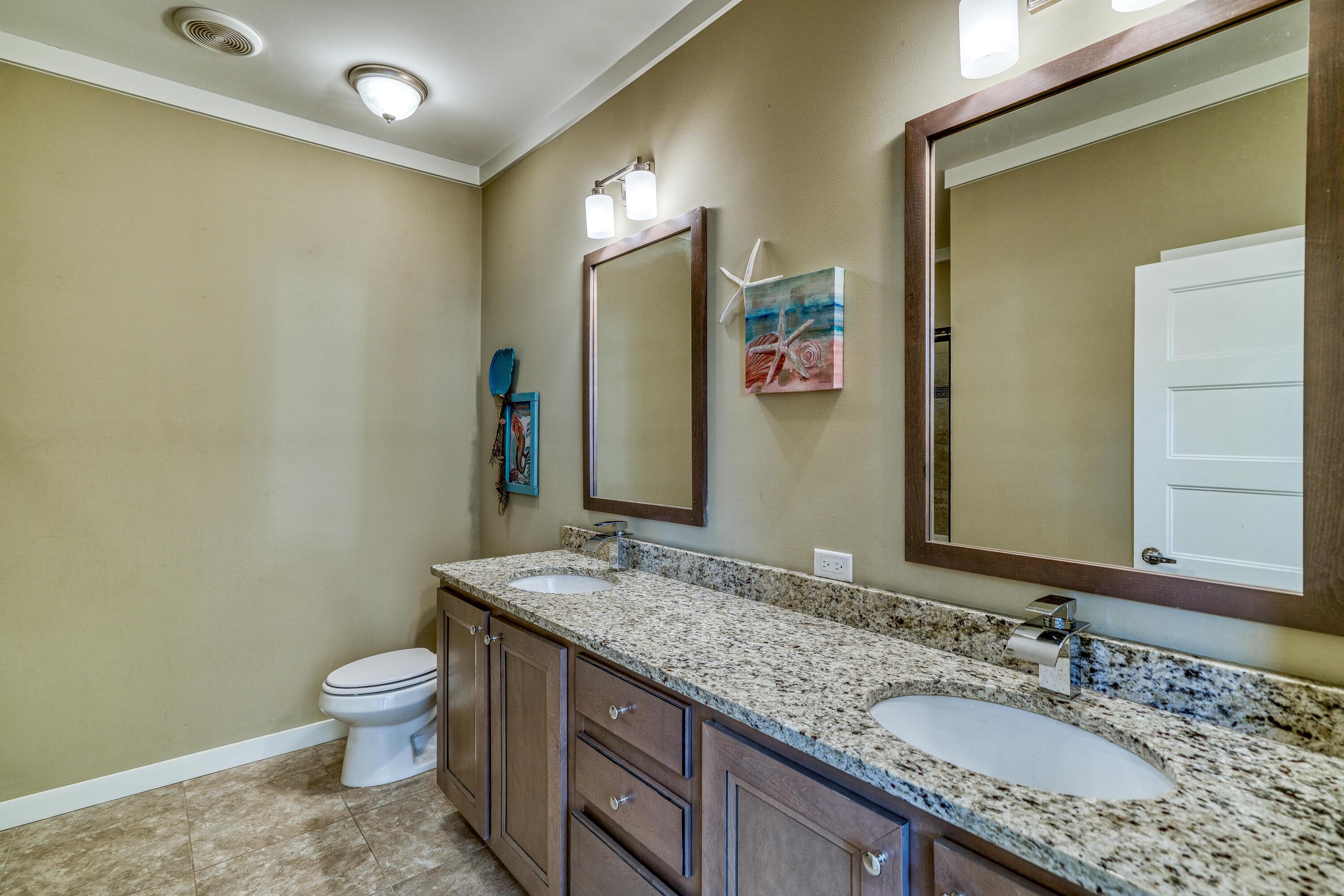 195 Maple Street Santa Rosa Beach, FL 32459 - Photo 11 of 29 a bathroom with a granite countertop sink toilet and mirror