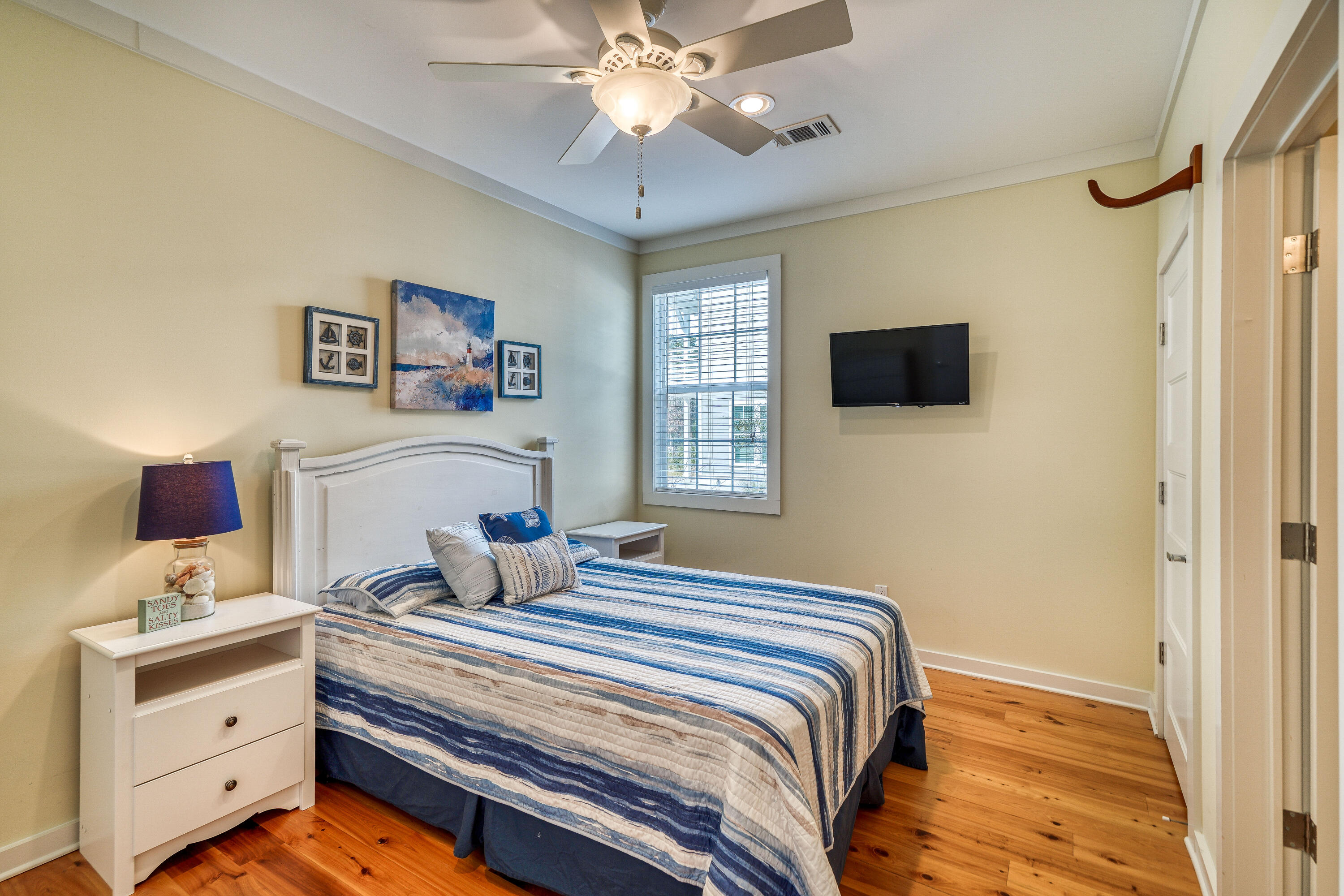 195 Maple Street Santa Rosa Beach, FL 32459 - Photo 13 of 29 a bedroom with a bed and wooden floor