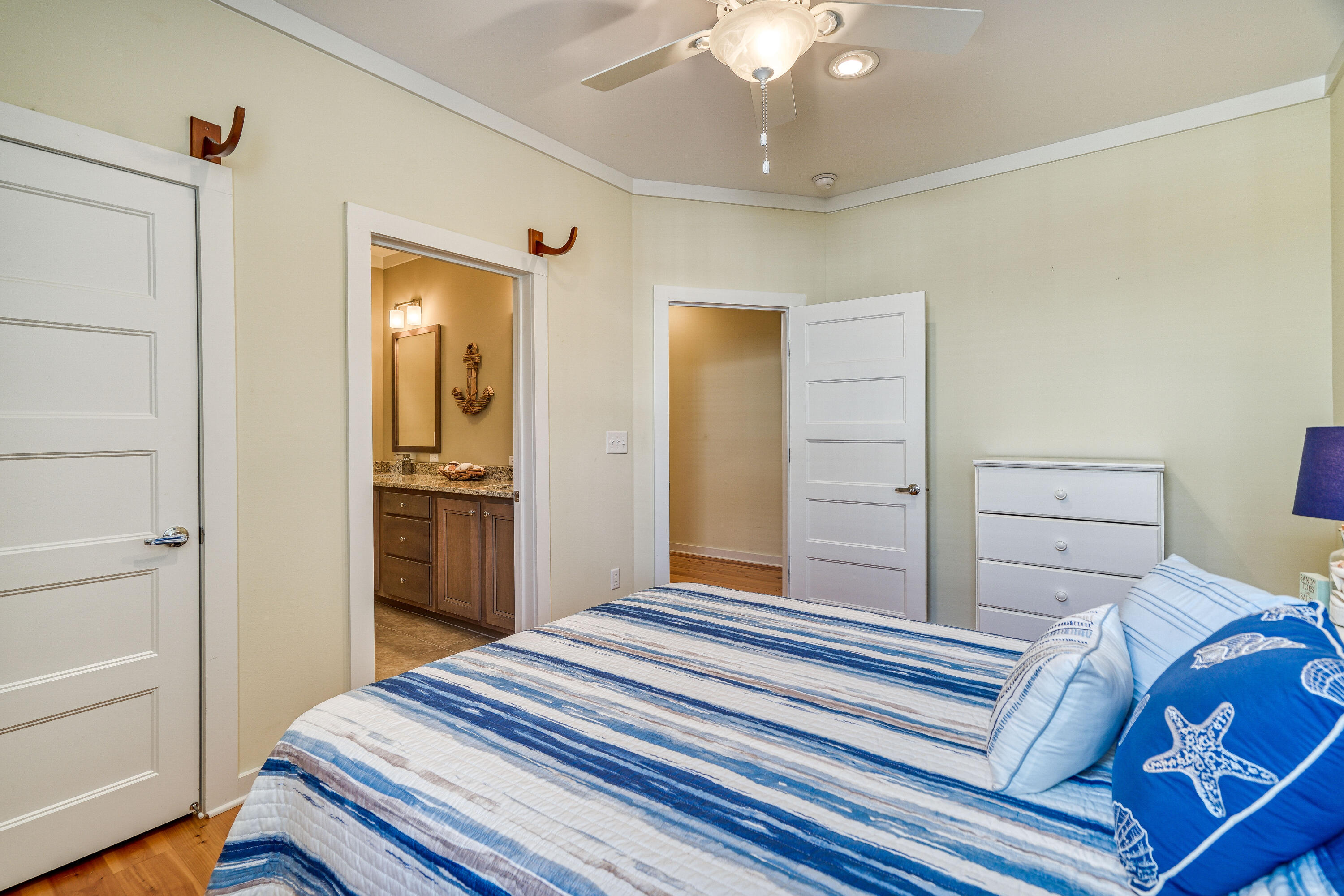 195 Maple Street Santa Rosa Beach, FL 32459 - Photo 14 of 29 a bedroom with a bed and a chandelier