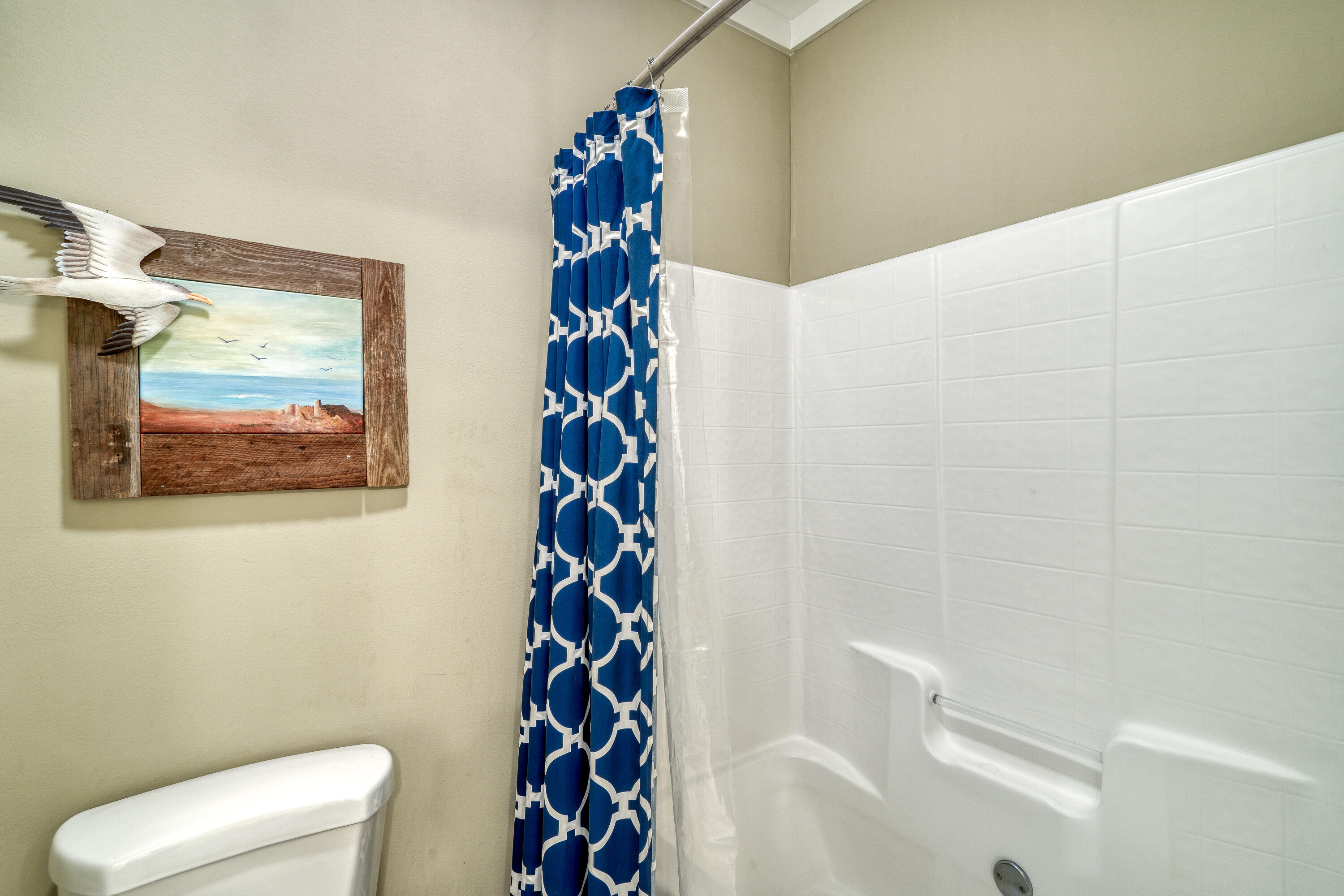 195 Maple Street Santa Rosa Beach, FL 32459 - Photo 16 of 29 a bathroom with a toilet and a shower curtain
