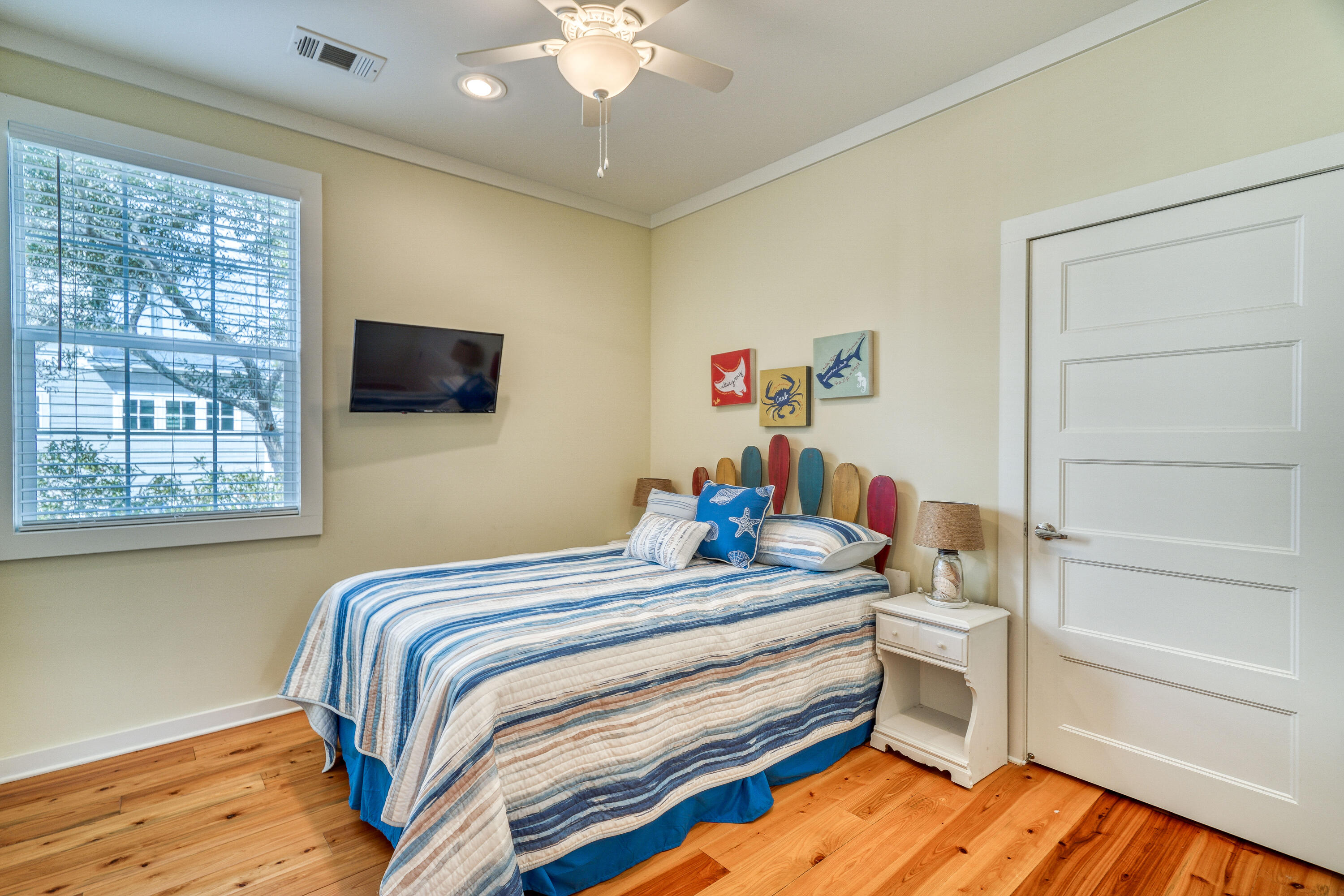 195 Maple Street Santa Rosa Beach, FL 32459 - Photo 17 of 29 a bedroom with a bed and wooden floor