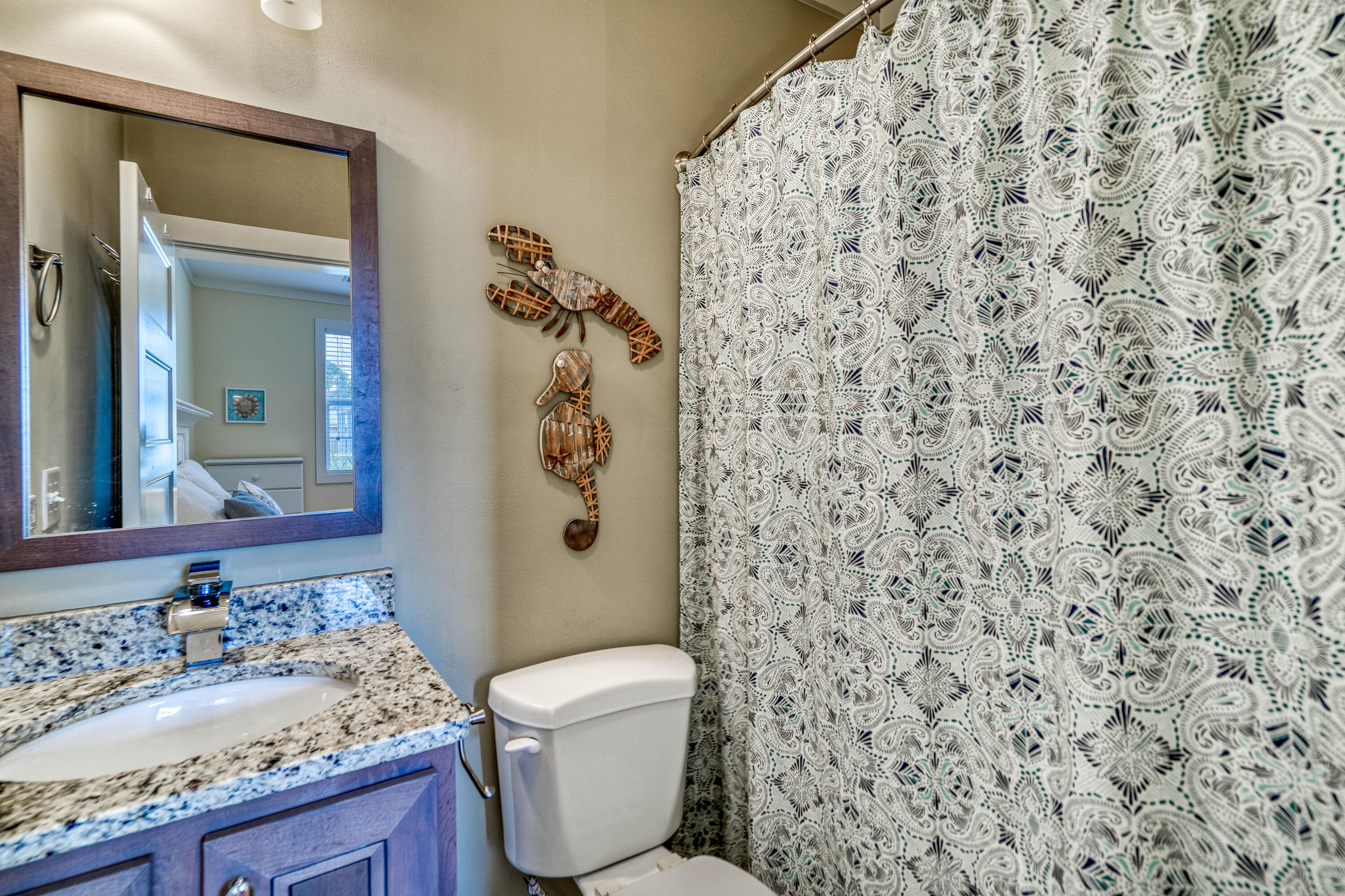 195 Maple Street Santa Rosa Beach, FL 32459 - Photo 19 of 29 a bathroom with a granite countertop toilet and a sink
