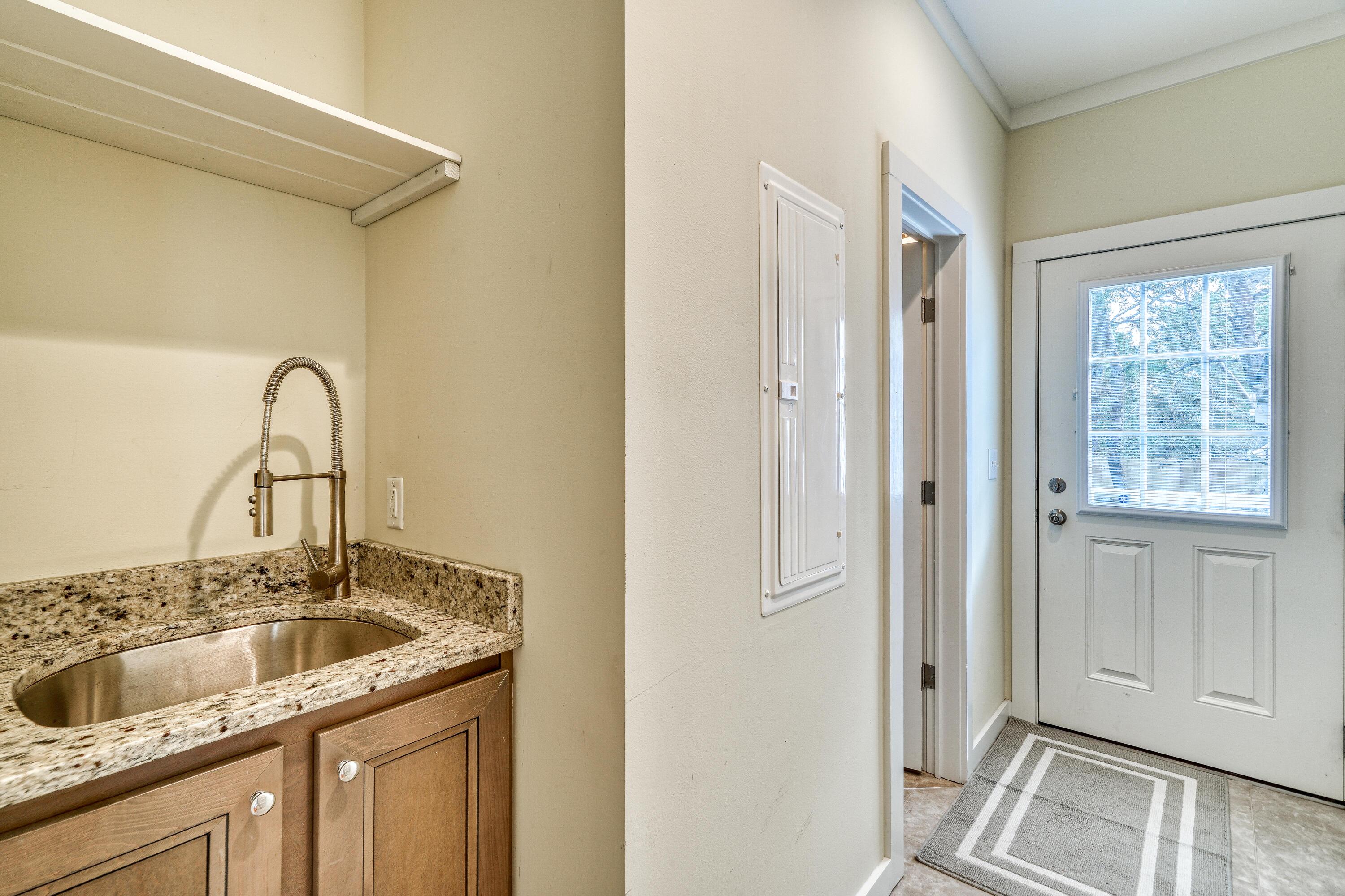195 Maple Street Santa Rosa Beach, FL 32459 - Photo 21 of 29 a kitchen with a sink and a refrigerator