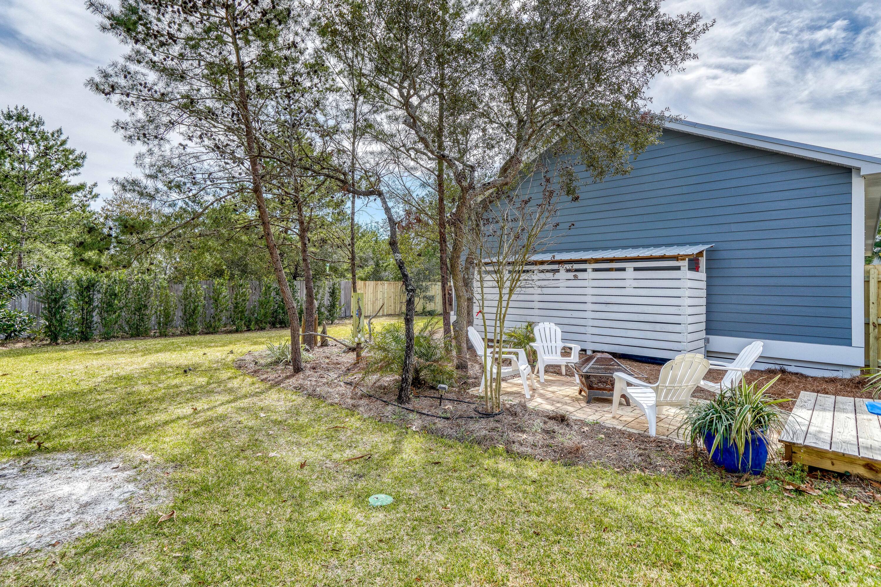195 Maple Street Santa Rosa Beach, FL 32459 - Photo 23 of 29 a backyard of a house with table and chairs