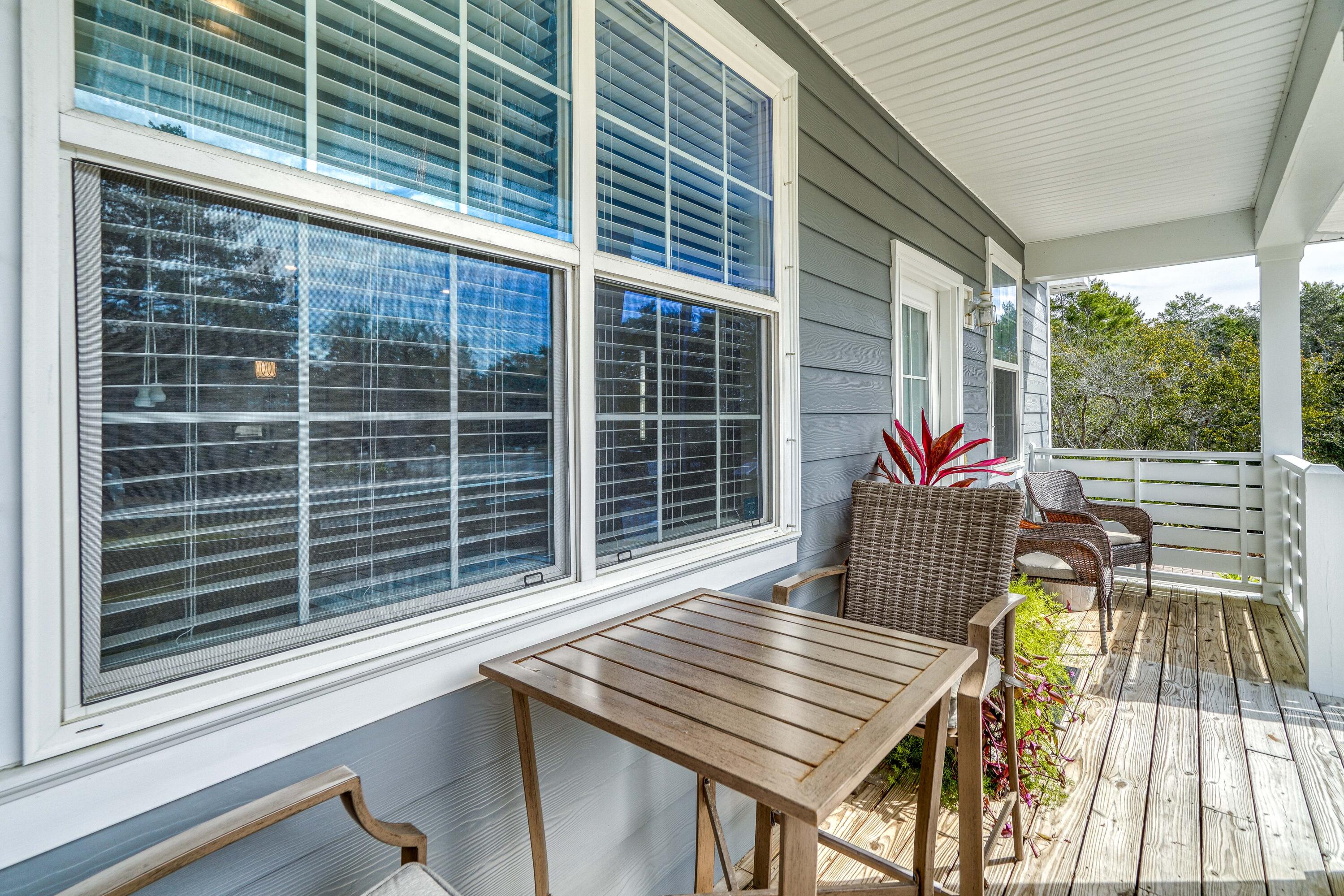 195 Maple Street Santa Rosa Beach, FL 32459 - Photo 3 of 29 a view of deck with a table and chairs and wooden floor