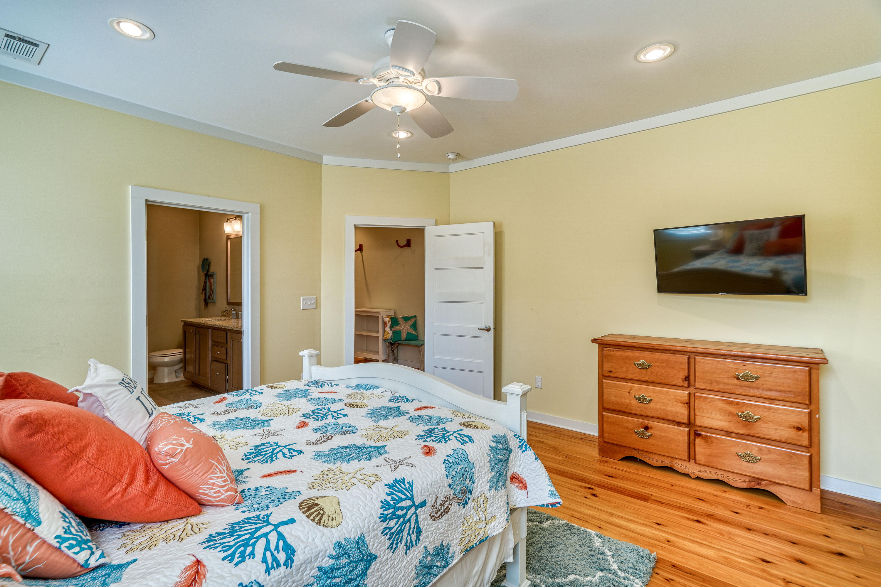 195 Maple Street Santa Rosa Beach, FL 32459 - Photo 10 of 29 a bedroom with a bed and wooden floor