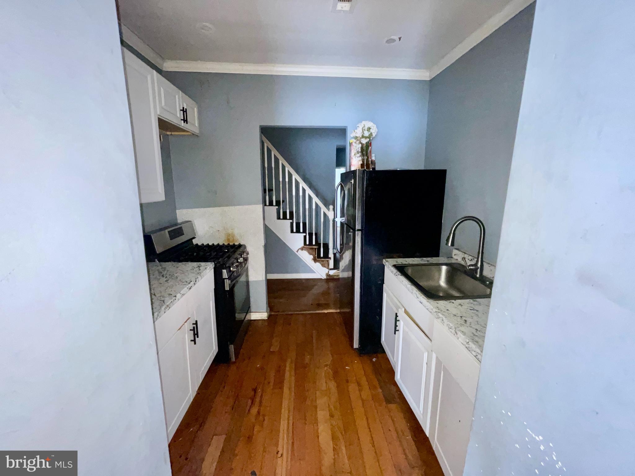 1905 Filmore Street Camden, NJ 08104 - Photo 4 of 10 a kitchen with granite countertop a stove and a sink