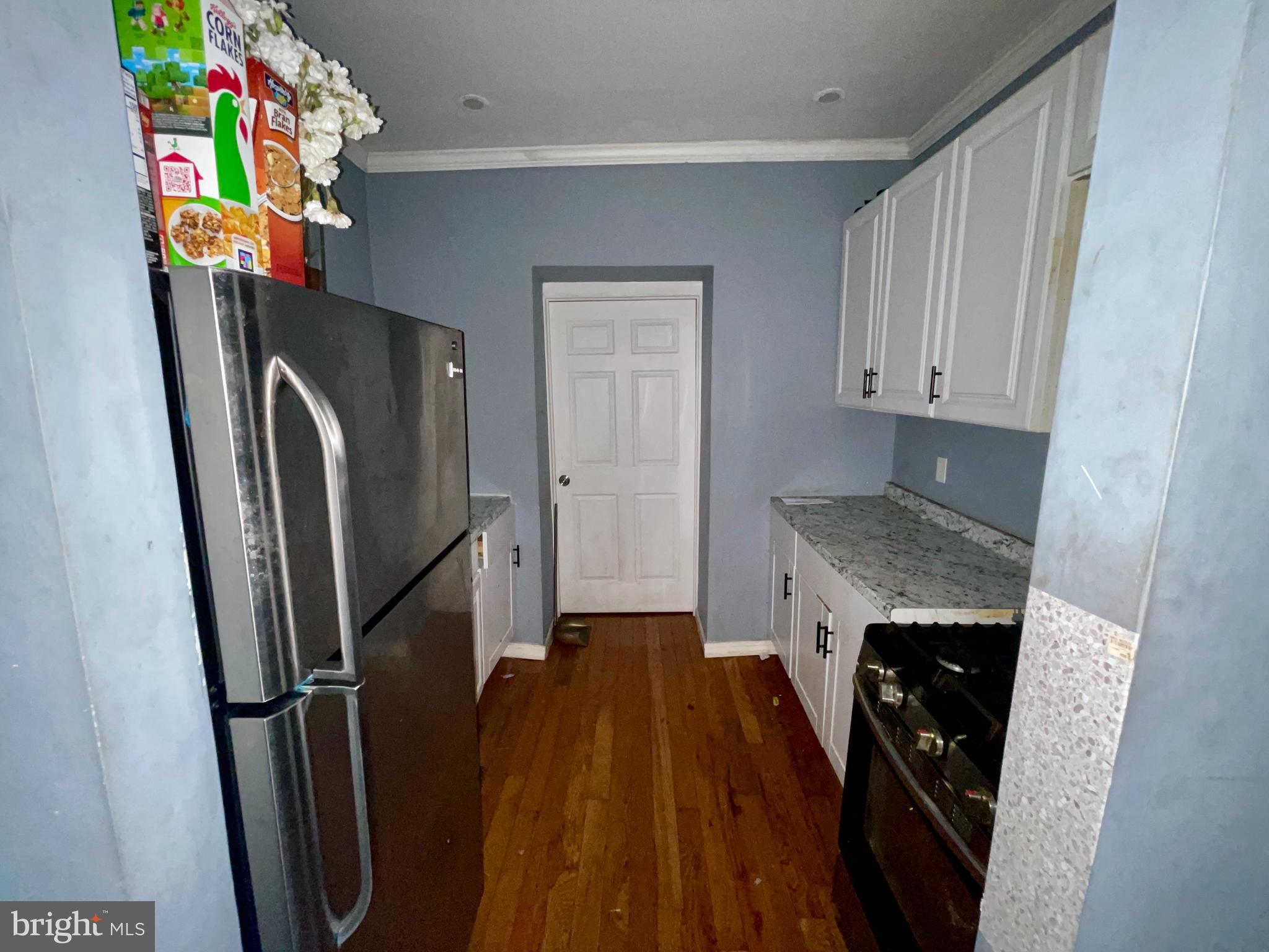 1905 Filmore Street Camden, NJ 08104 - Photo 5 of 10 a view of washer and dryer with wooden floor