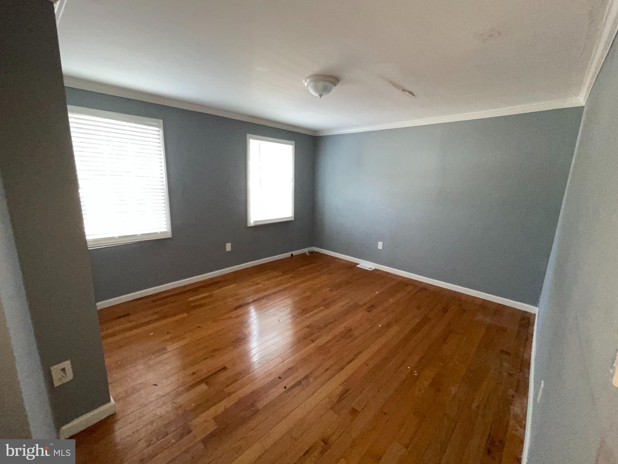 1905 Filmore Street Camden, NJ 08104 - Photo 7 of 10 an empty room with wooden floor and windows